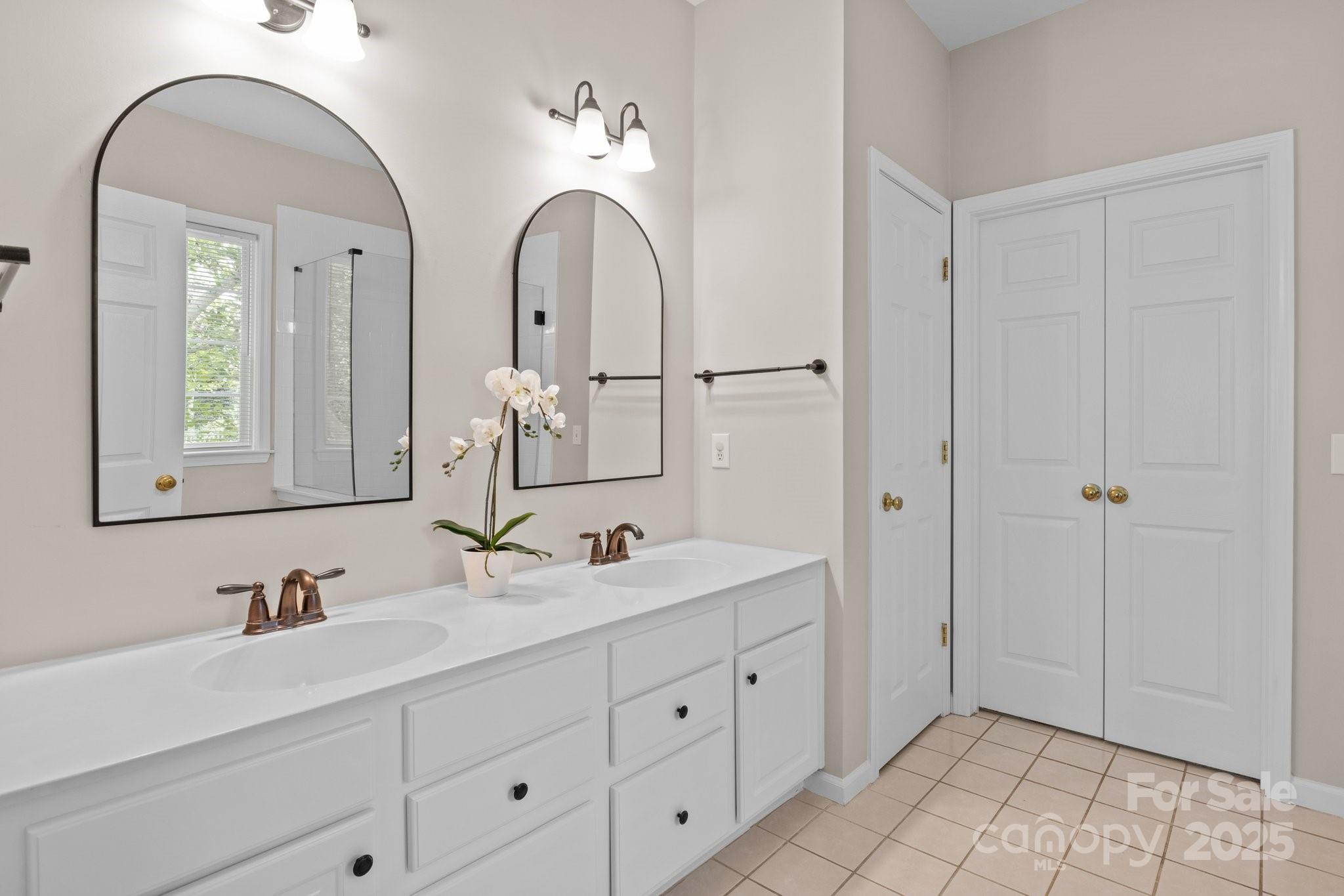 7710 Epping Forest Drive Huntersville, NC 28078 - Photo 20 of 37 a bathroom with a double vanity sink and a mirror