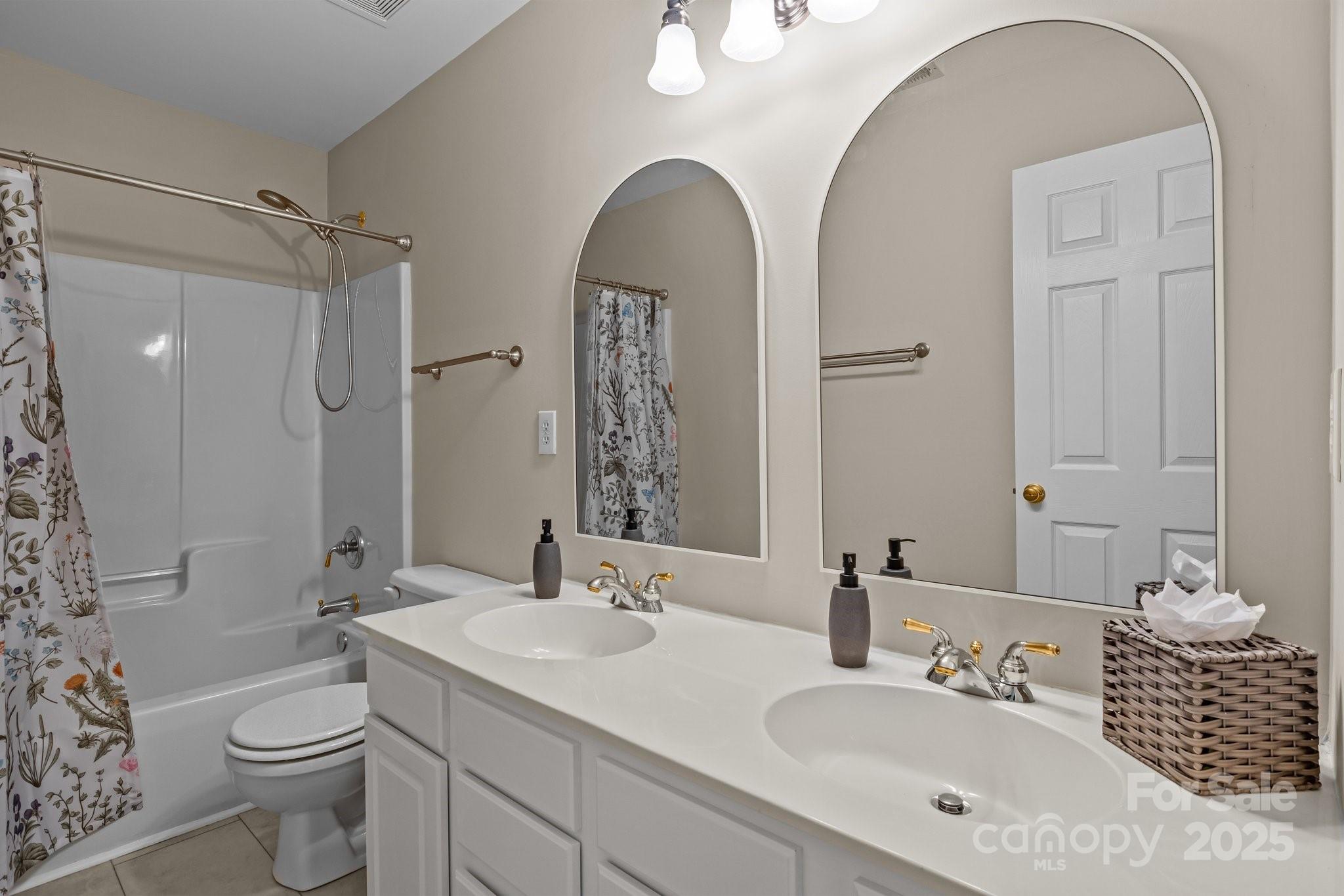 7710 Epping Forest Drive Huntersville, NC 28078 - Photo 25 of 37 a bathroom with a toilet sink and mirror