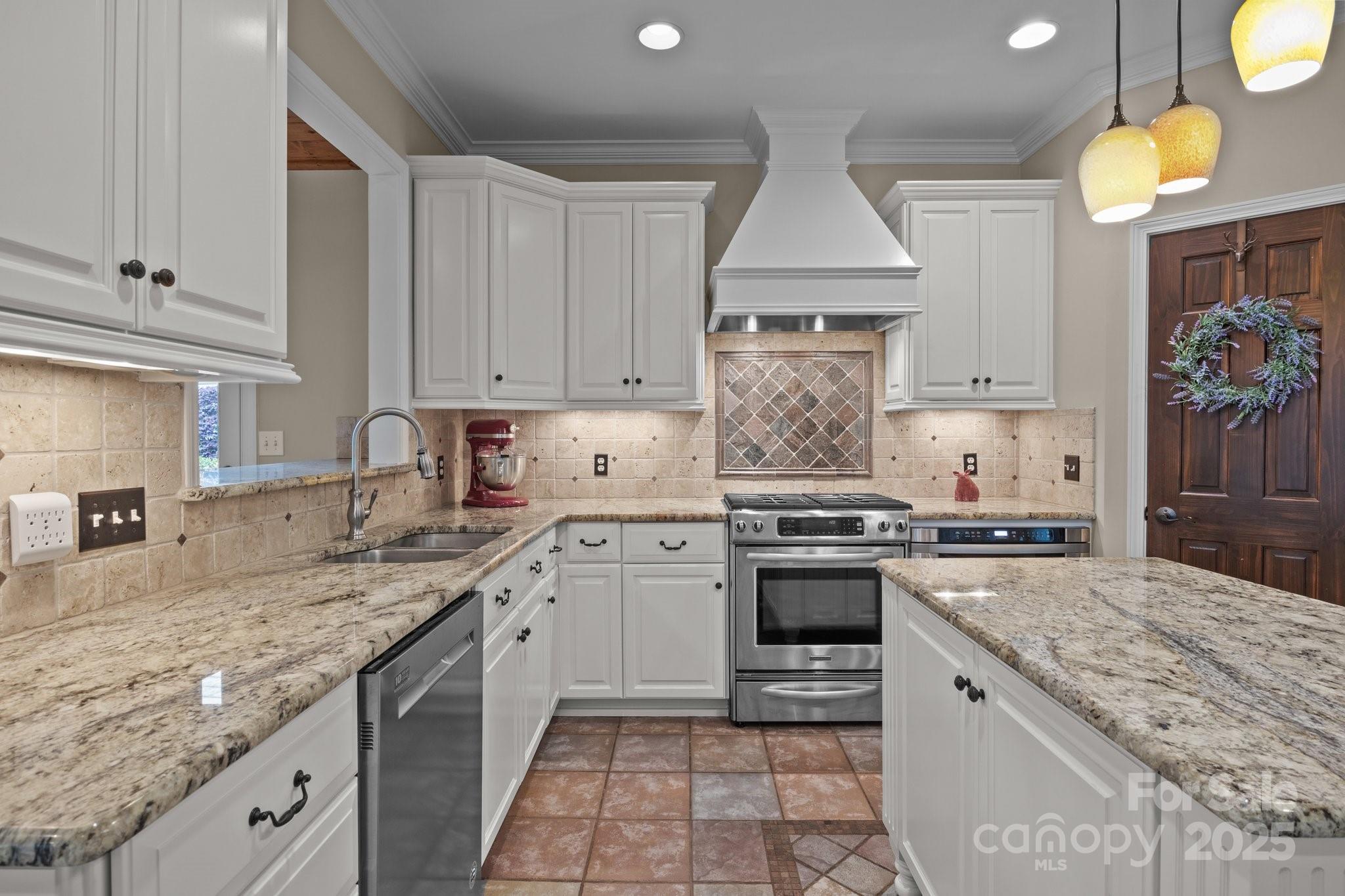 7710 Epping Forest Drive Huntersville, NC 28078 - Photo 7 of 37 a kitchen with stainless steel appliances granite countertop a stove sink and cabinets