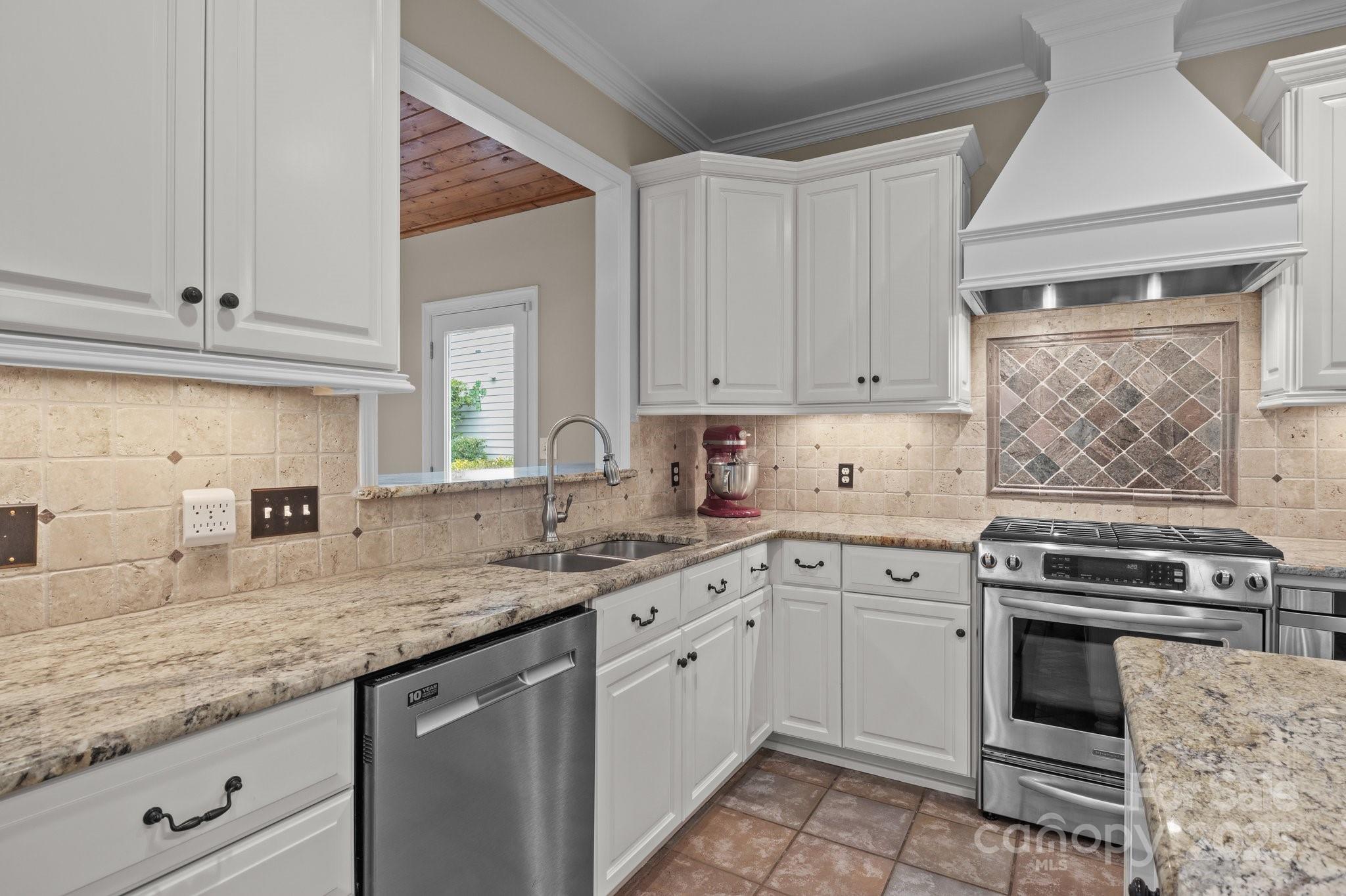 7710 Epping Forest Drive Huntersville, NC 28078 - Photo 9 of 37 a kitchen with granite countertop a sink cabinets stainless steel appliances and a counter space