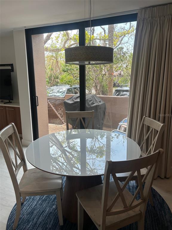 111 Pass Key Road, Unit 111 Sarasota, FL 34242 - Photo 12 of 23 a view of a dining room with furniture and window