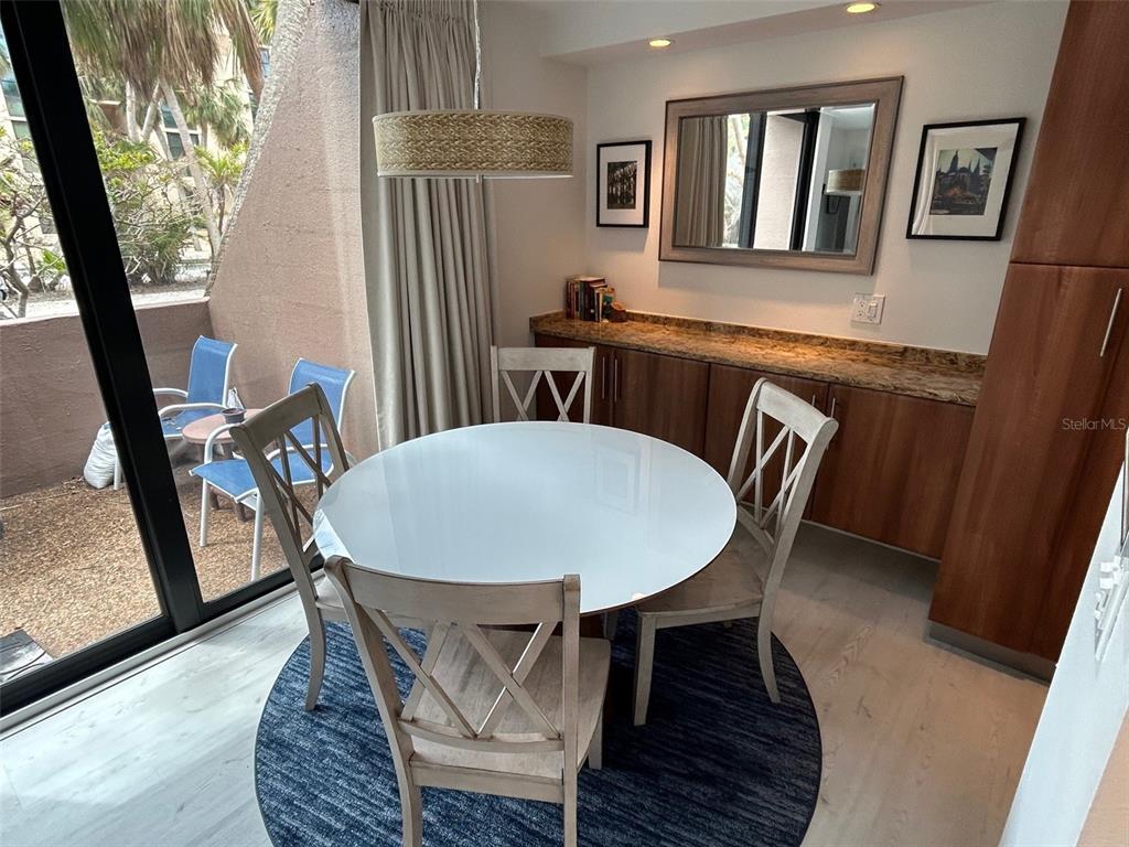 111 Pass Key Road, Unit 111 Sarasota, FL 34242 - Photo 13 of 23 a view of a dining room with furniture window and wooden floor
