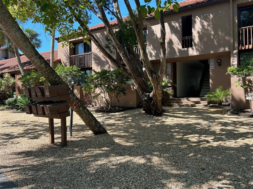 111 Pass Key Road, Unit 111 Sarasota, FL 34242 - Photo 2 of 23 a front view of a house with a tree