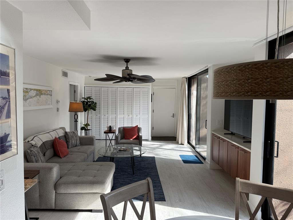 111 Pass Key Road, Unit 111 Sarasota, FL 34242 - Photo 4 of 23 a living room with furniture and a flat screen tv