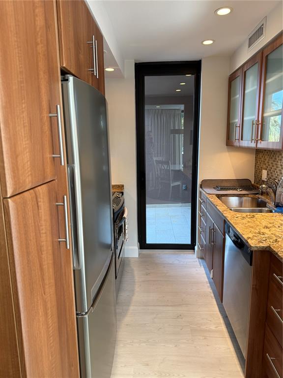 111 Pass Key Road, Unit 111 Sarasota, FL 34242 - Photo 9 of 23 a kitchen with stainless steel appliances granite countertop a refrigerator and a sink