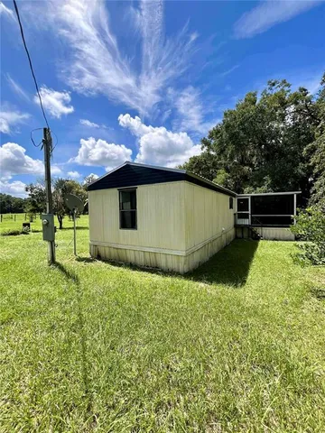 a backyard of a house with lots of green space