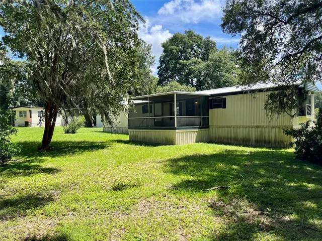 a view of a house with backyard and garden