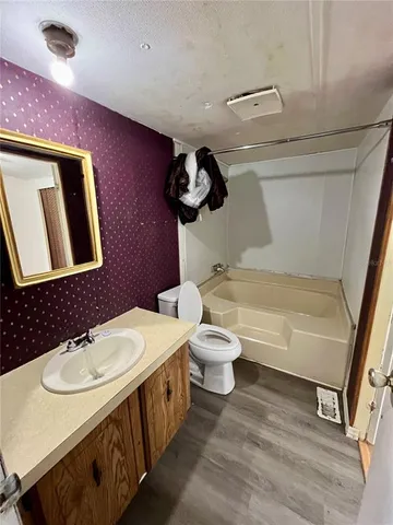 a bathroom with a sink a toilet and bathtub