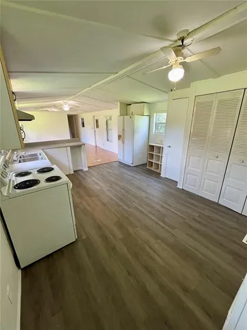 a living room with furniture and a ceiling fan