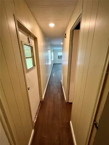a view of a hallway with wooden floor