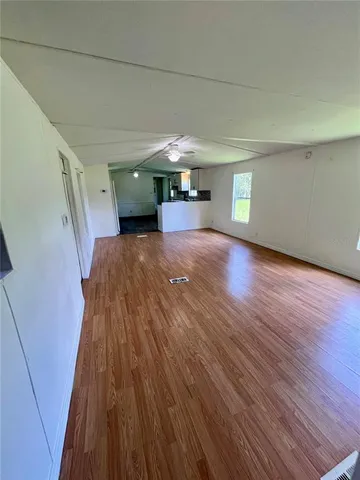 a view of a room with wooden floor