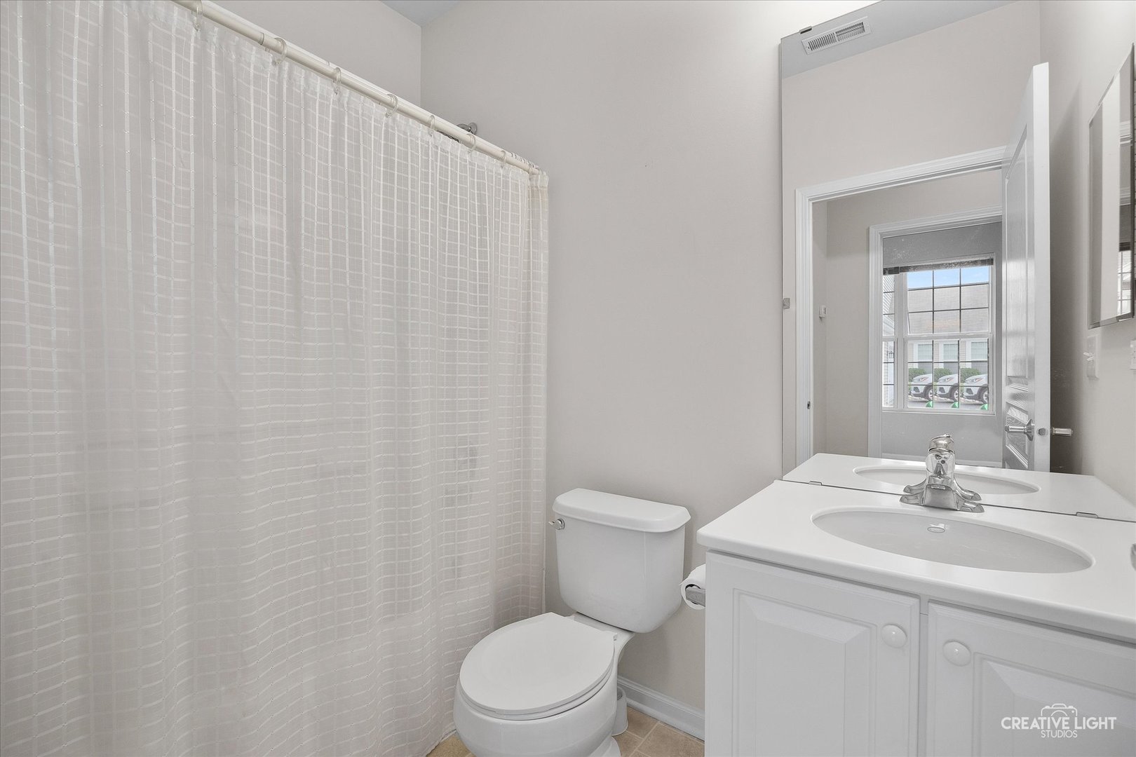 13611 Hemlock Road Huntley, IL 60142 - Photo 5 of 16 a bathroom with a sink a toilet and shower curtain