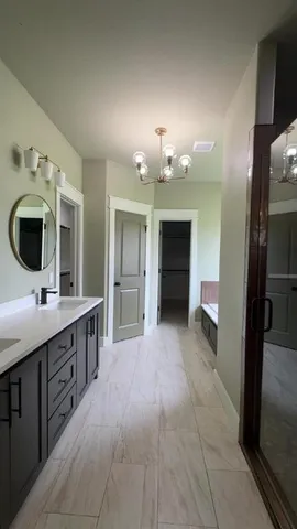 a large bathroom with a sink and a large mirror