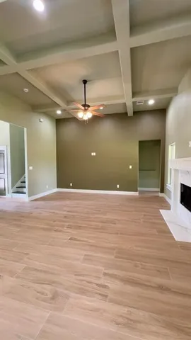 a view of a room with a ceiling fan and window