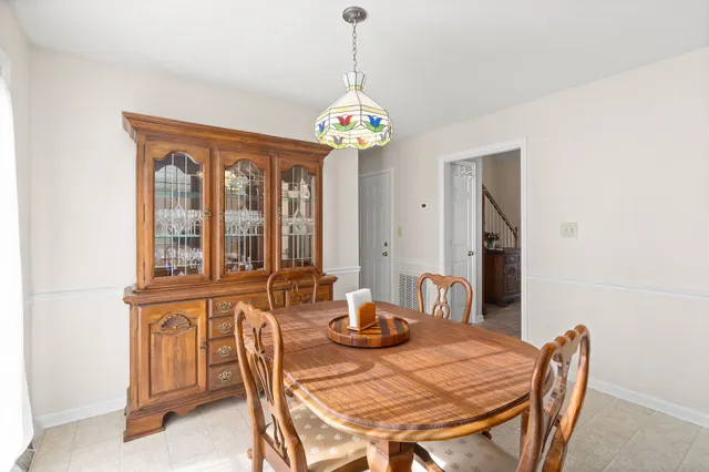 a view of a dining room with furniture wooden floor and chandelier