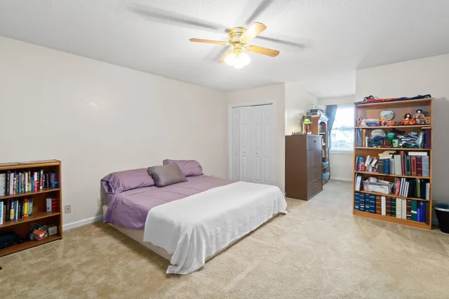 a bedroom with a bed and a book shelf