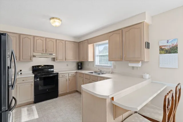 a kitchen with a sink cabinets and window