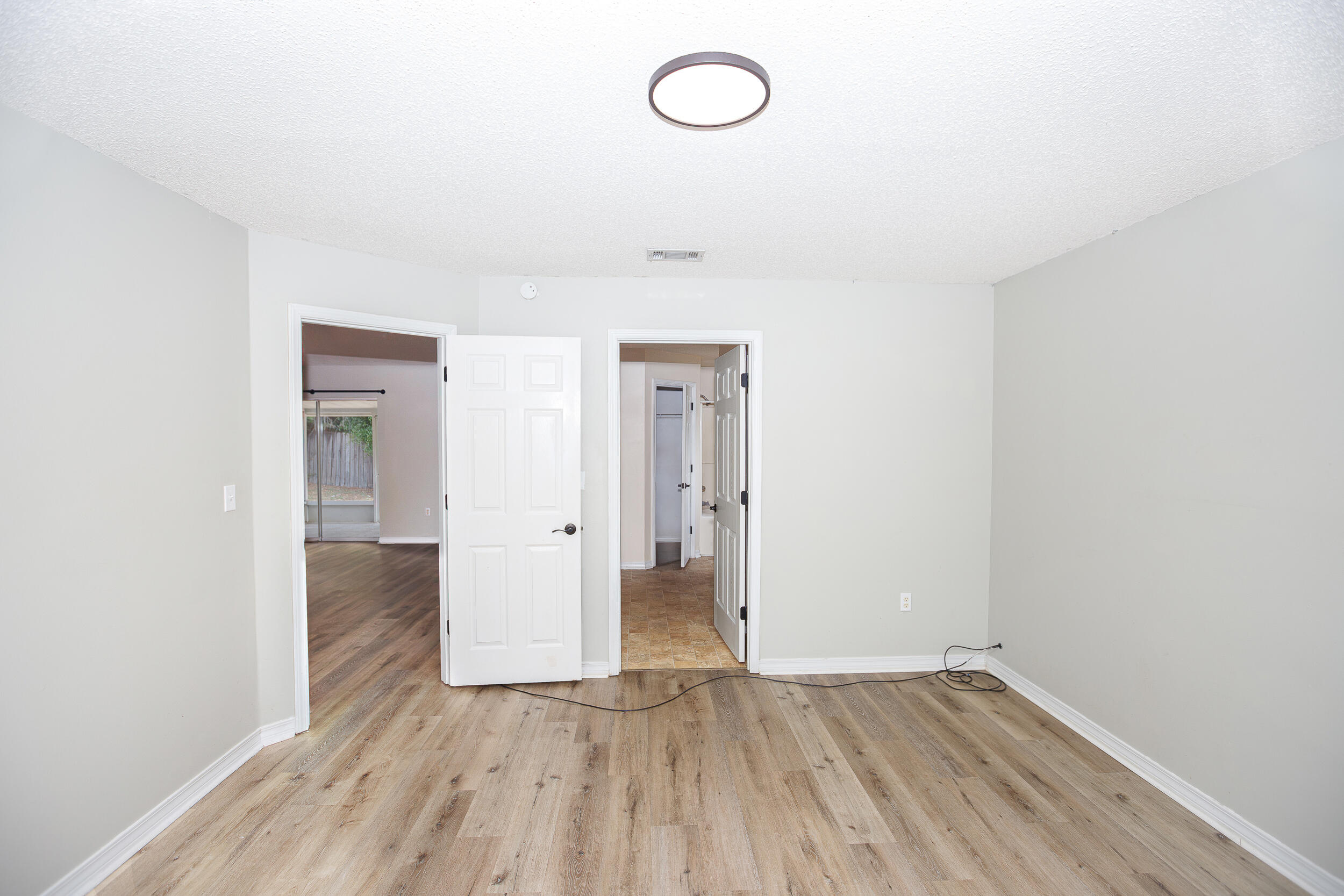 1305 Jefferyscot Court Crestview, FL 32536 - Photo 12 of 20 a view of a room with wooden floor and a sink