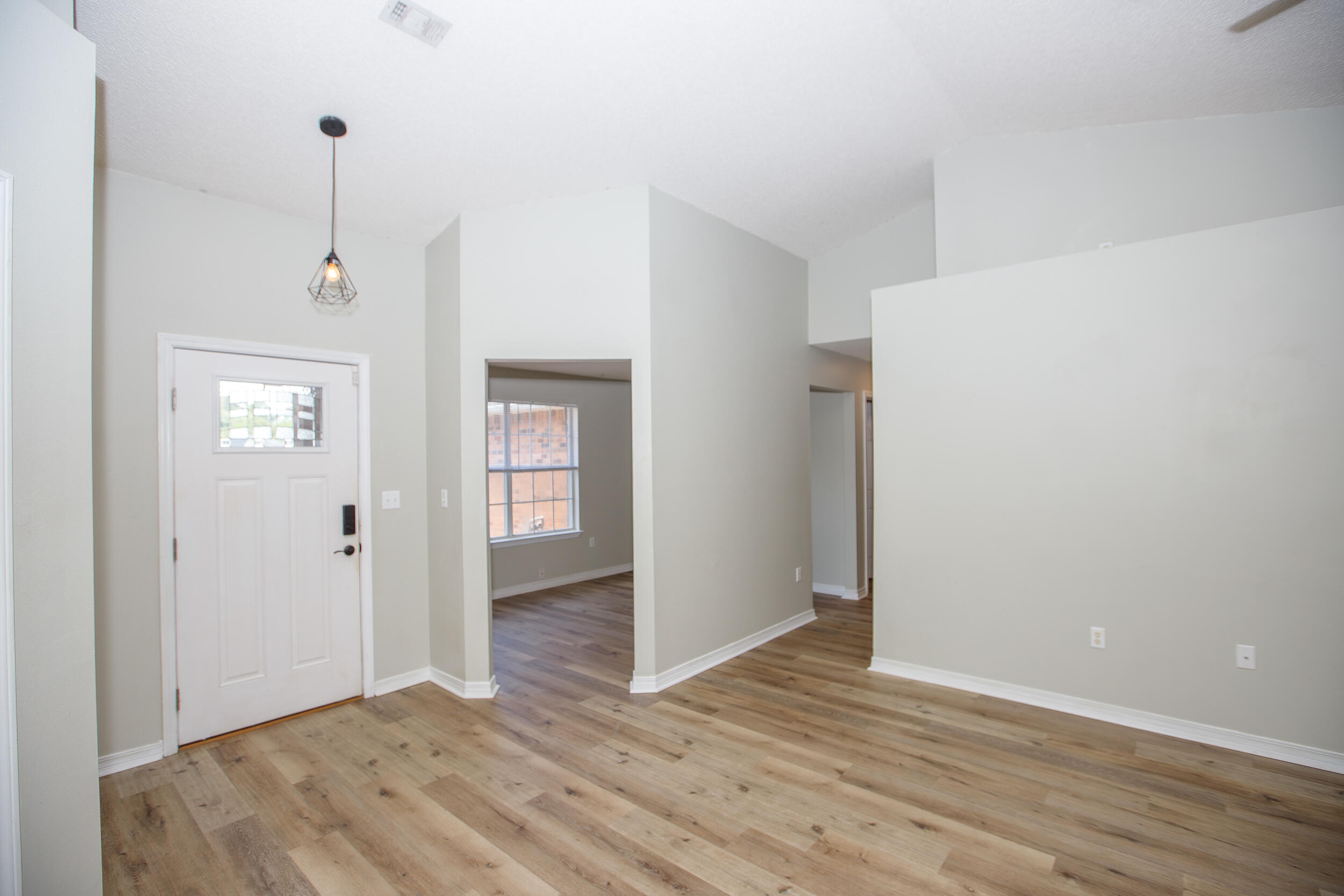 1305 Jefferyscot Court Crestview, FL 32536 - Photo 2 of 20 a view of an empty room with wooden floor and a window