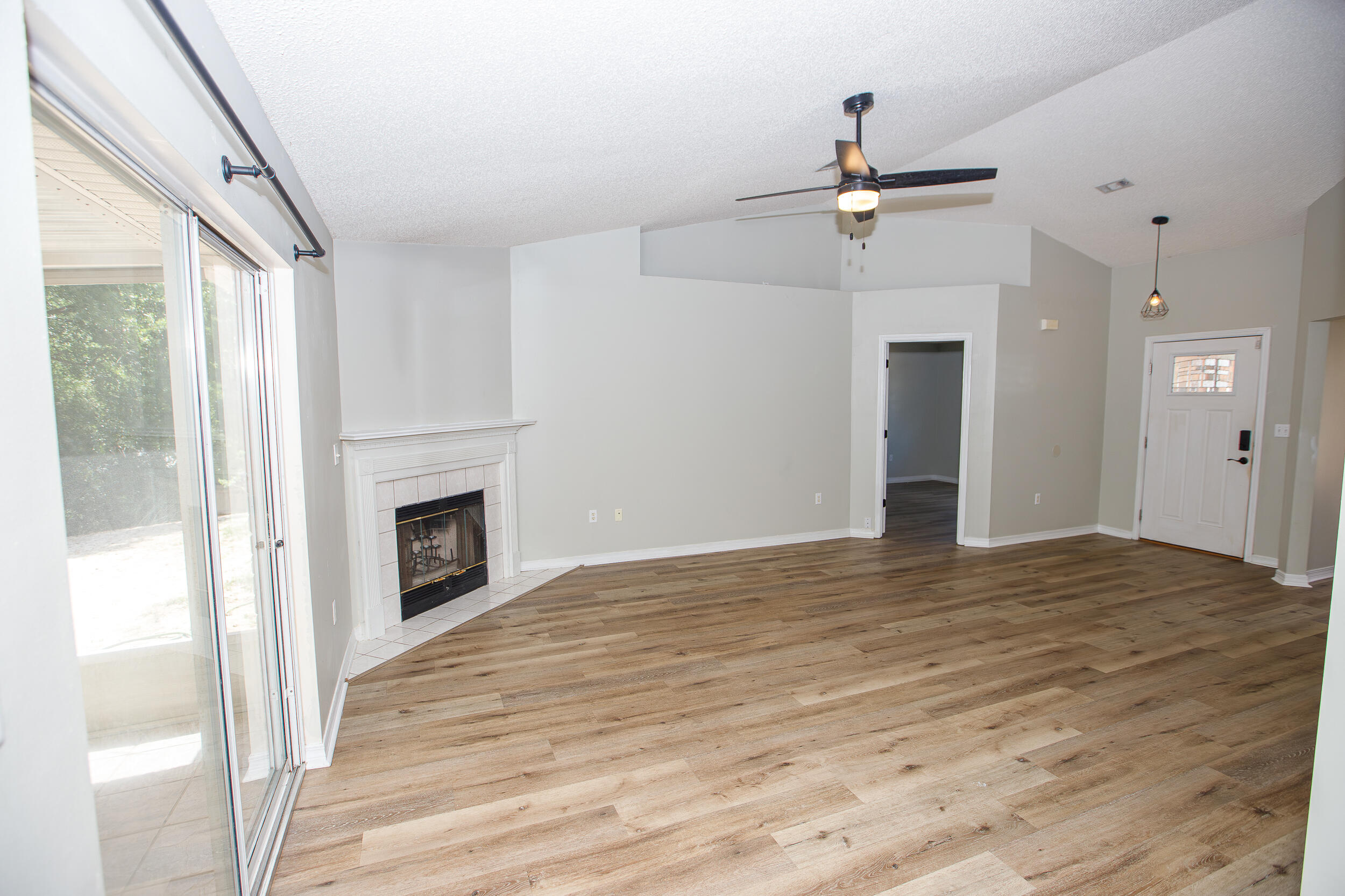 1305 Jefferyscot Court Crestview, FL 32536 - Photo 4 of 20 a view of empty room with fireplace and wooden floor