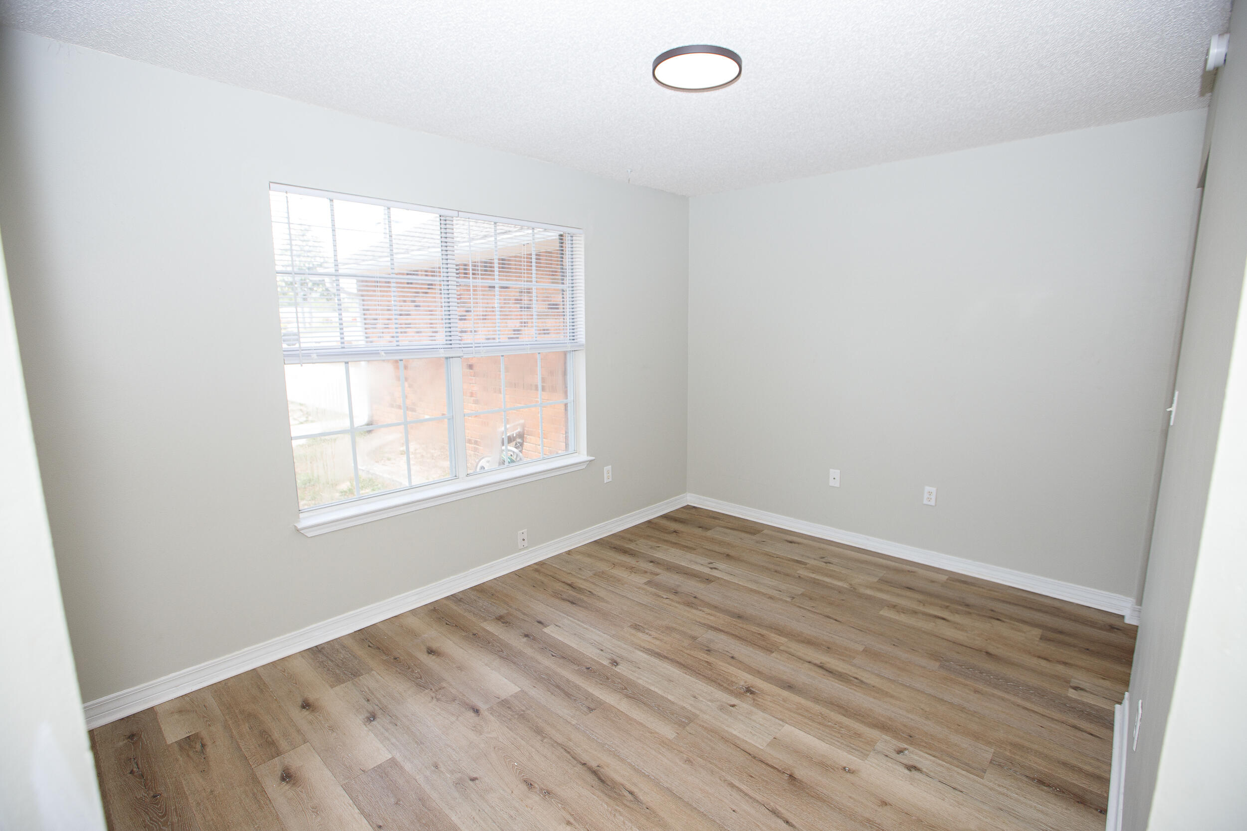 1305 Jefferyscot Court Crestview, FL 32536 - Photo 5 of 20 an empty room with wooden floor and windows