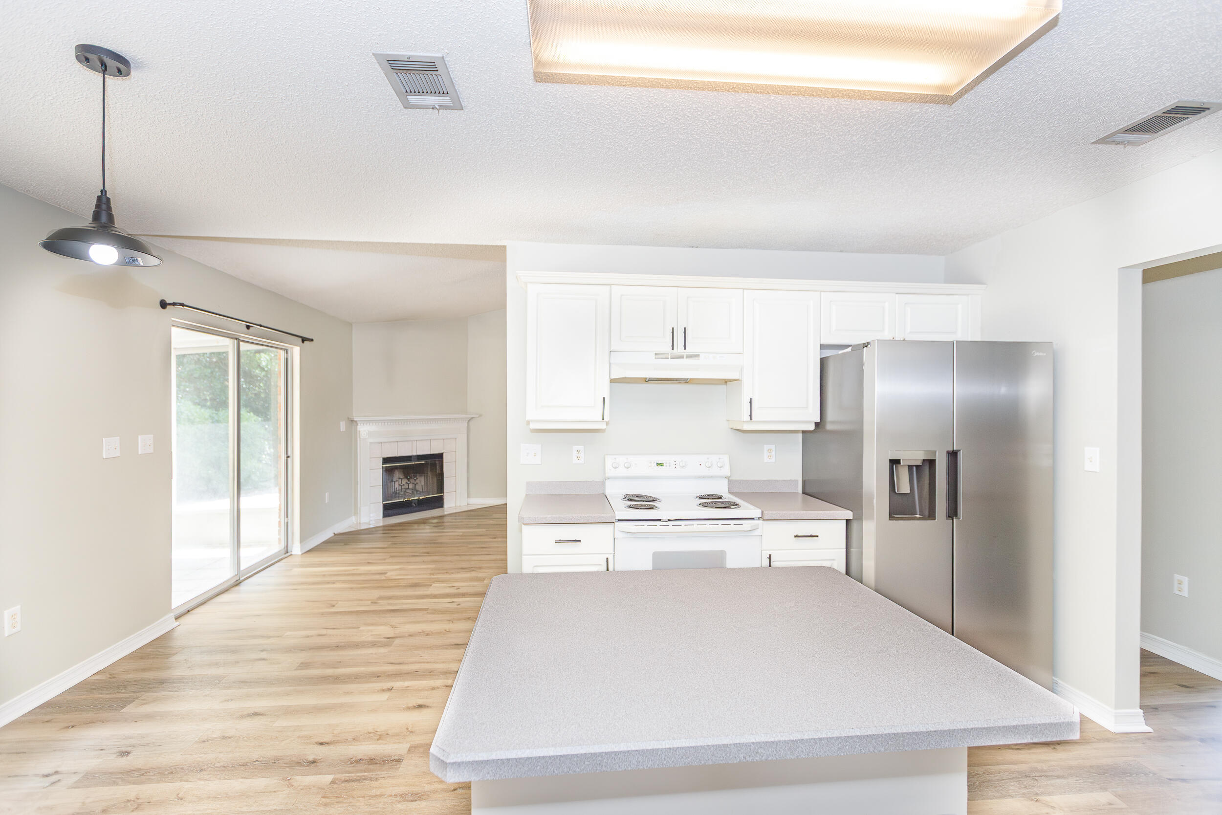 1305 Jefferyscot Court Crestview, FL 32536 - Photo 6 of 20 a large white kitchen with cabinets and stainless steel appliances