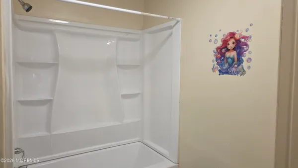 a bathroom with a glass door shower and a shower