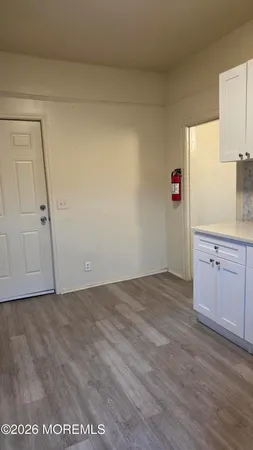 a view of kitchen with granite countertop cabinets and sink
