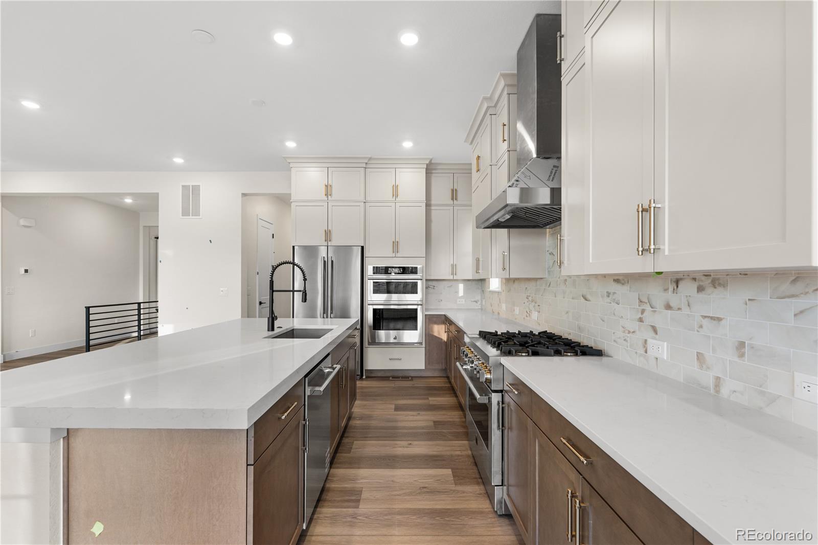 6749 Fawn Path Lane Castle Pines, CO 80108 - Photo 13 of 33 a kitchen with stainless steel appliances granite countertop a sink a stove and a refrigerator