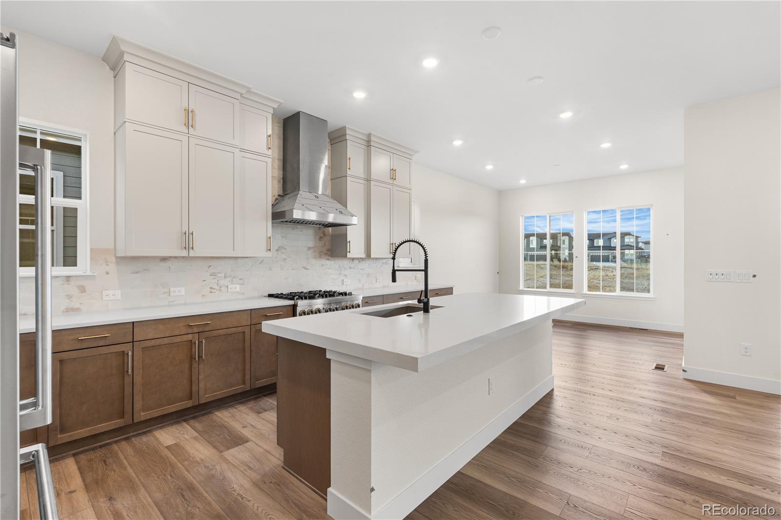 6749 Fawn Path Lane Castle Pines, CO 80108 - Photo 16 of 33 a large kitchen with stainless steel appliances granite countertop a lot of counter space and wooden floors