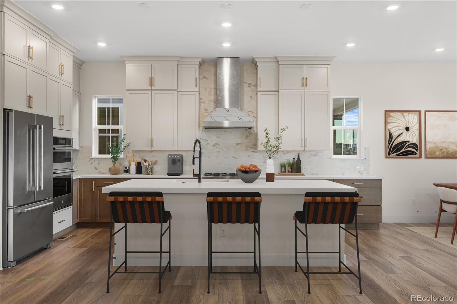 6749 Fawn Path Lane Castle Pines, CO 80108 - Photo 5 of 33 a kitchen with a table chairs refrigerator and microwave