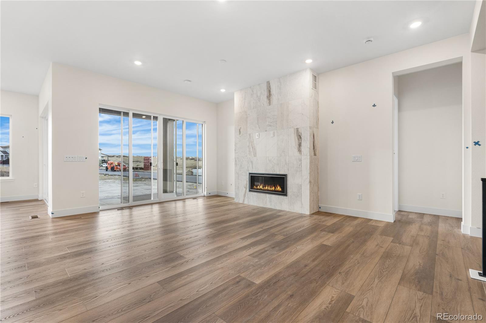 6749 Fawn Path Lane Castle Pines, CO 80108 - Photo 10 of 33 a view of empty room with wooden floor and fireplace