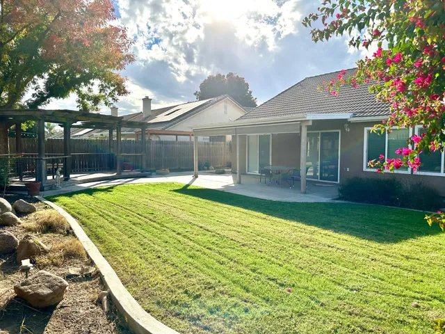 a swimming pool with outdoor seating and yard