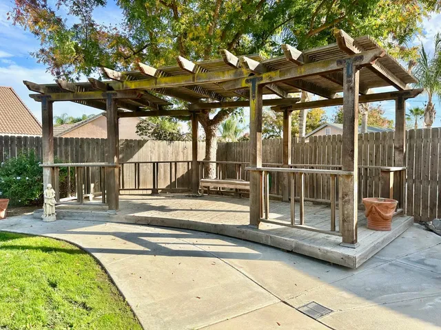 a view of a patio with a table and chairs under an umbrella