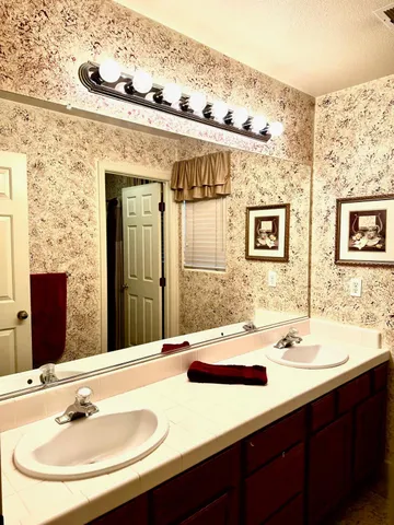 a bathroom with a sink and a mirror