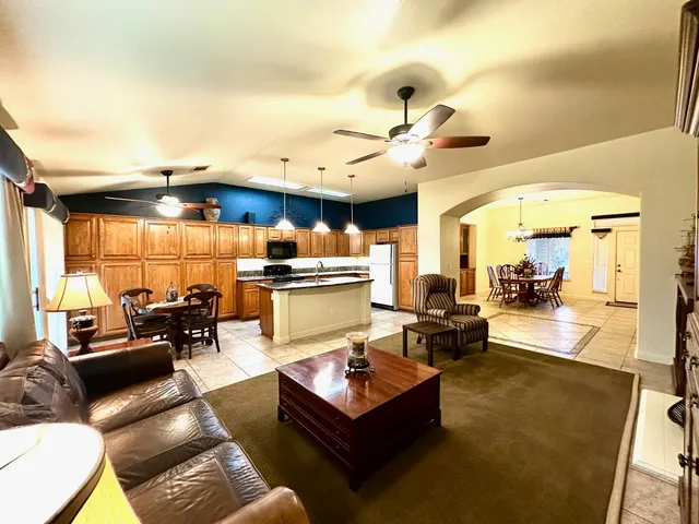 a living room with fireplace furniture and a chandelier
