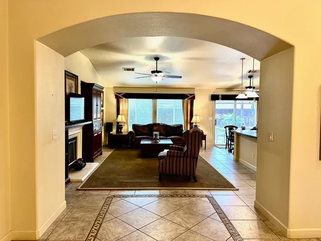 a living room with furniture a dining table and kitchen view