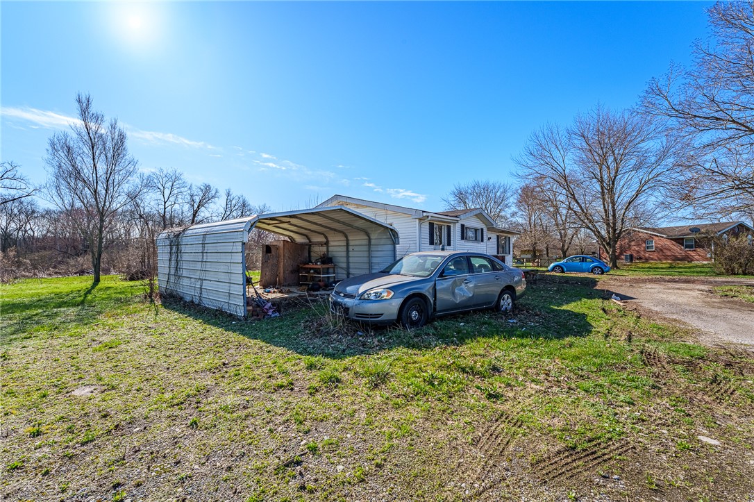 7315 Franklin-Trenton Road Franklin, OH 45005 - Photo 3 of 15 This property features a spacious yard and functional outbuilding, offering versatile outdoor living and storage solutions.