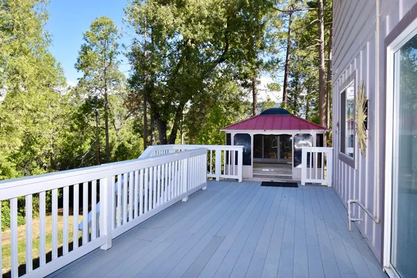 a view of balcony with wooden floor and fence