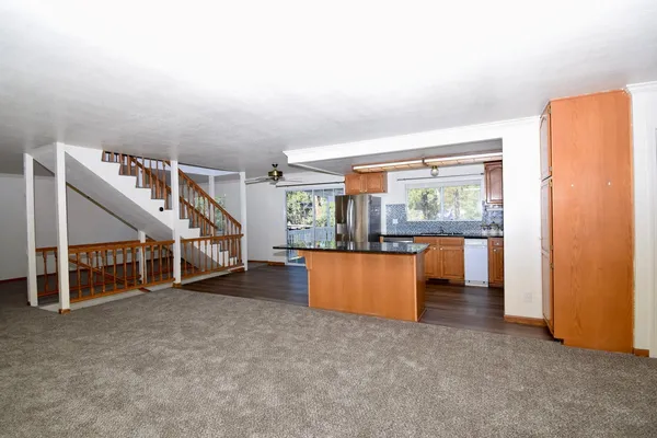 an empty room with furniture and a large window
