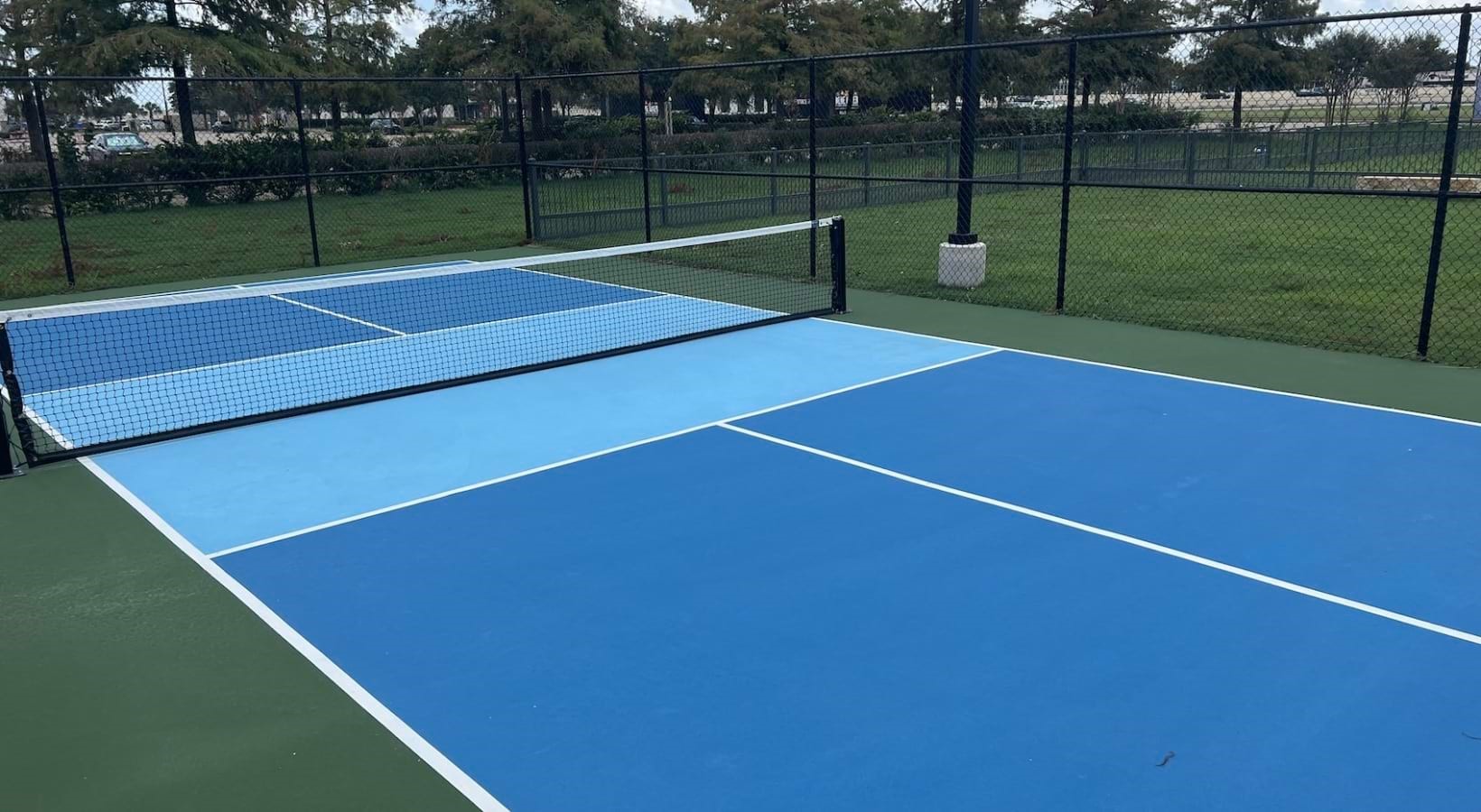 19101 Town Ridge Lane, Unit 7117 Webster, TX 77598 - Photo 26 of 30 a view of a tennis court