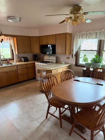 a large kitchen with a table and chairs in it