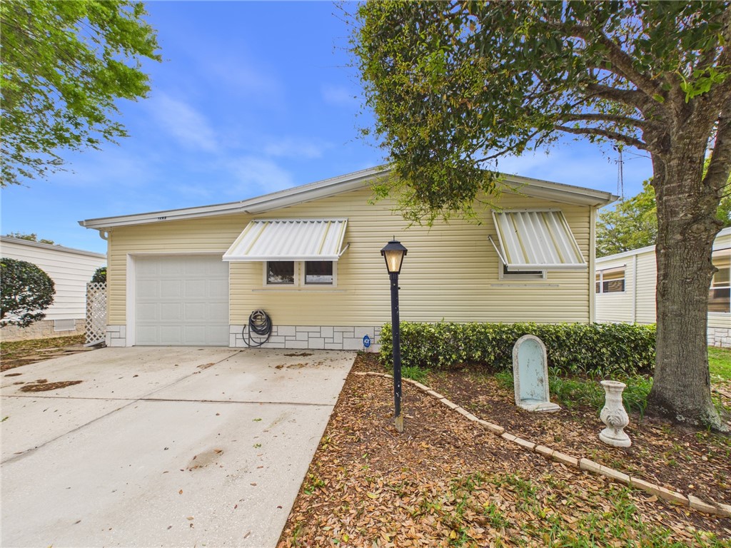 1203 Calusa Drive Sebastian, FL 32976 - Photo 1 of 27 a front view of a house with garden