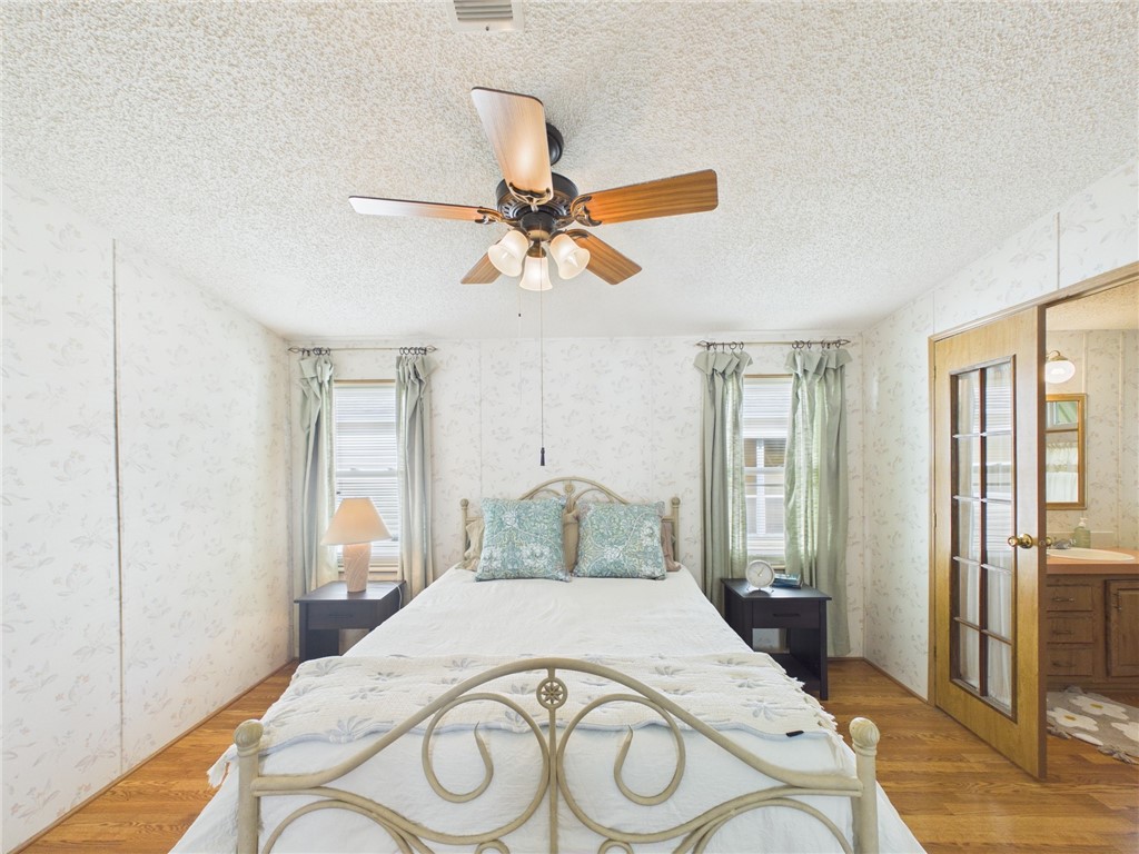 1203 Calusa Drive Sebastian, FL 32976 - Photo 14 of 27 a bedroom with a bed and a chandelier