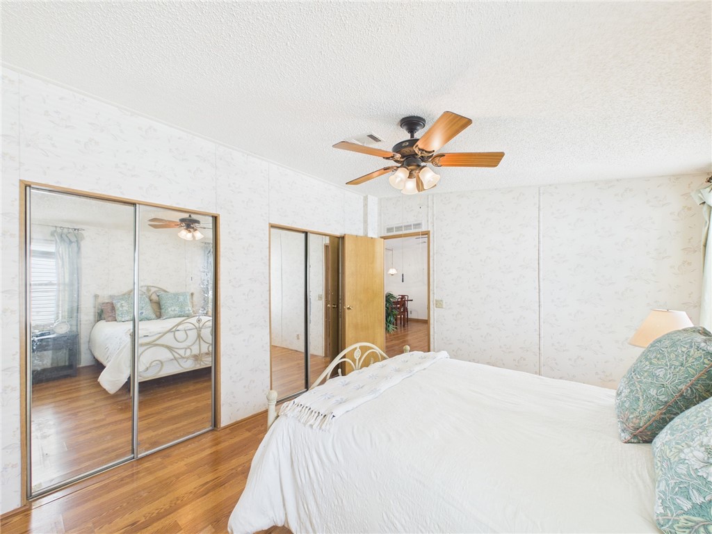 1203 Calusa Drive Sebastian, FL 32976 - Photo 16 of 27 a bedroom with a bed and a chandelier