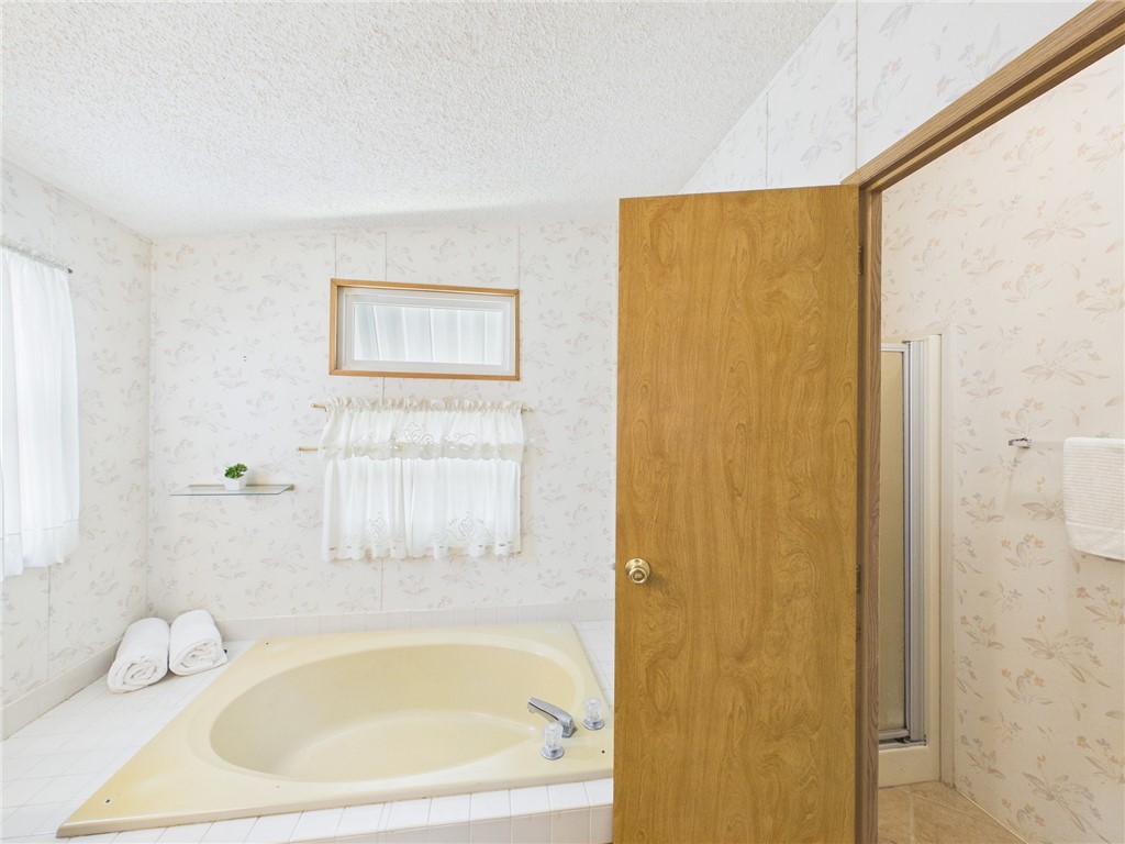 1203 Calusa Drive Sebastian, FL 32976 - Photo 18 of 27 a white bath tub sitting next to a white sink