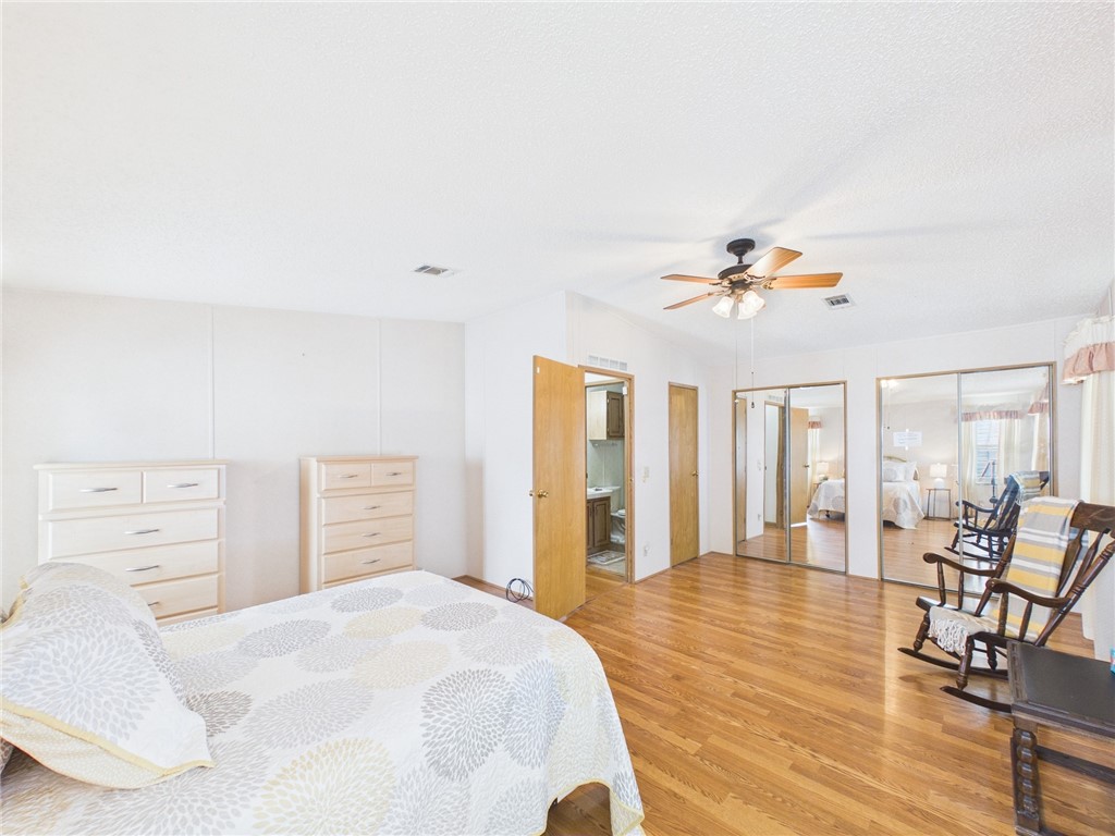 1203 Calusa Drive Sebastian, FL 32976 - Photo 20 of 27 a bedroom with a bed and wooden floor