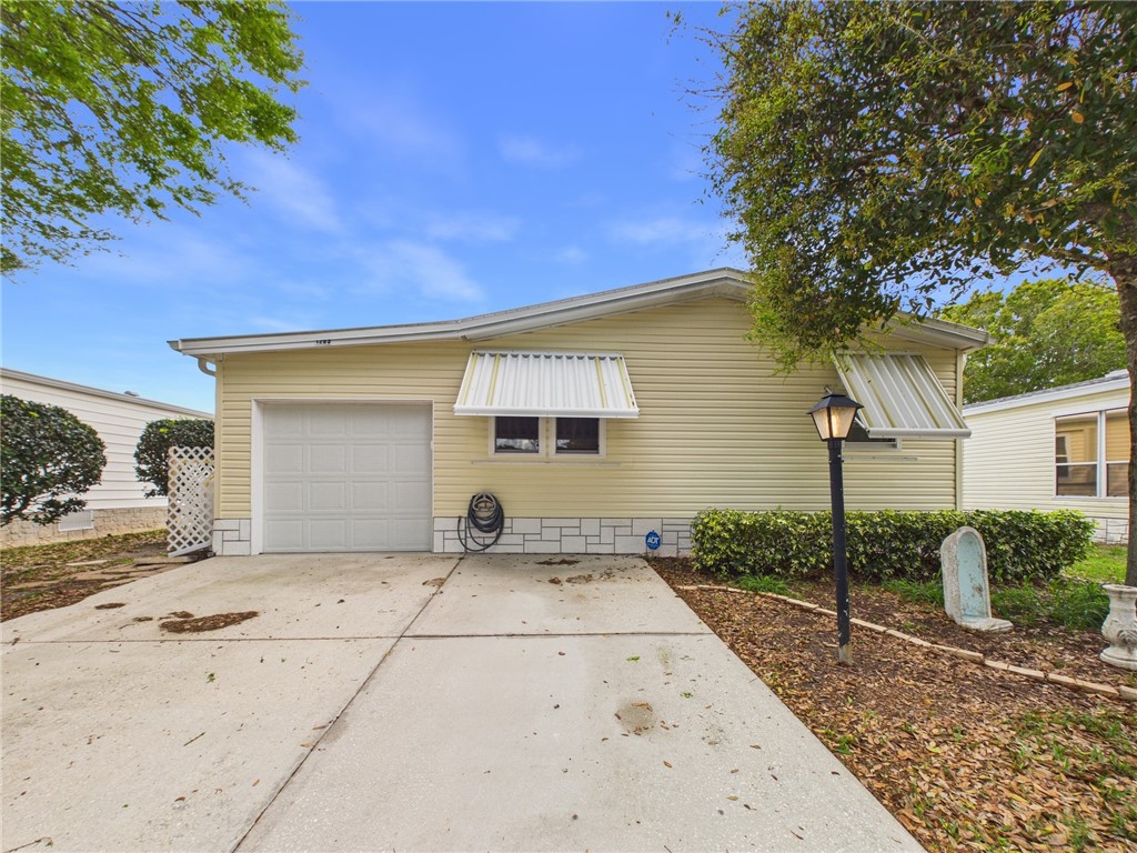 1203 Calusa Drive Sebastian, FL 32976 - Photo 2 of 27 a view of a house with a yard