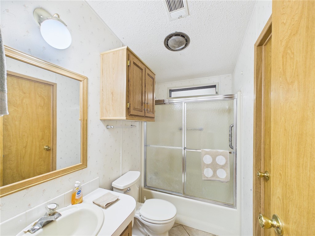 1203 Calusa Drive Sebastian, FL 32976 - Photo 24 of 27 a bathroom with a sink mirror toilet and shower