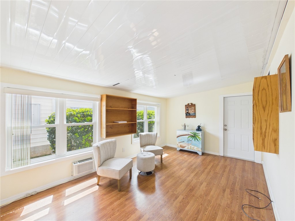 1203 Calusa Drive Sebastian, FL 32976 - Photo 27 of 27 a living room with furniture and a wooden floor